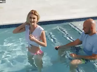 Tiny blonde facialized after sex with ball bruiser by the pool